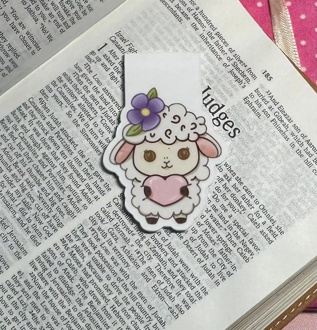 Cute cartoon sheep bookmark with a flower on an open book