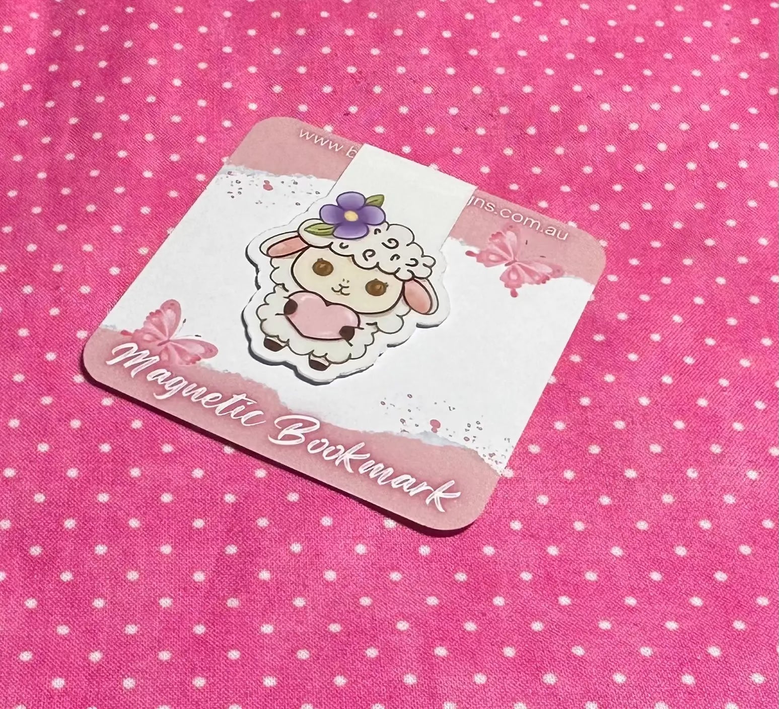 Magnetic bookmark with cartoon design on a pink polka dot background