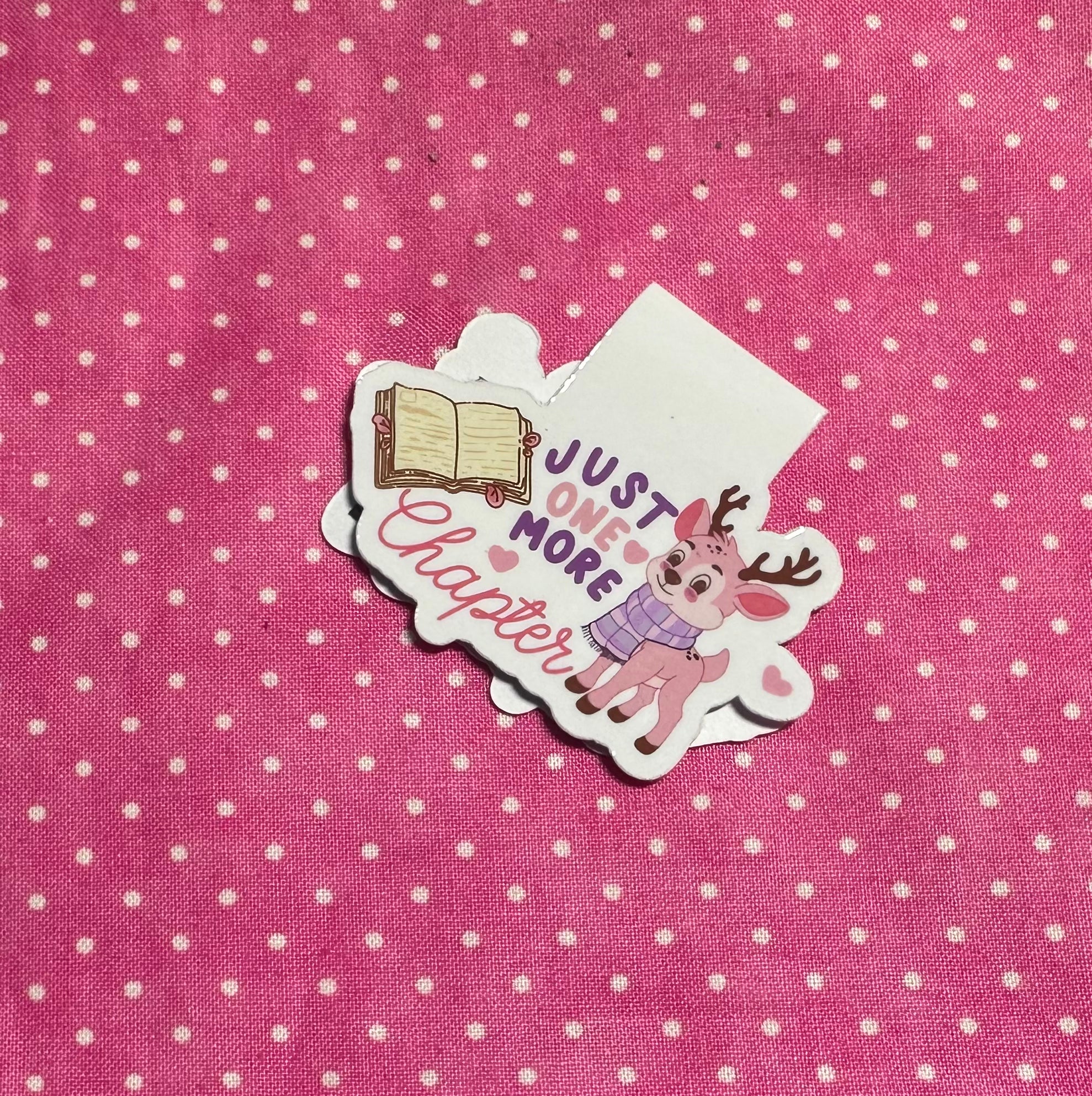 Sticker with a cartoon deer and text on a pink polka dot background