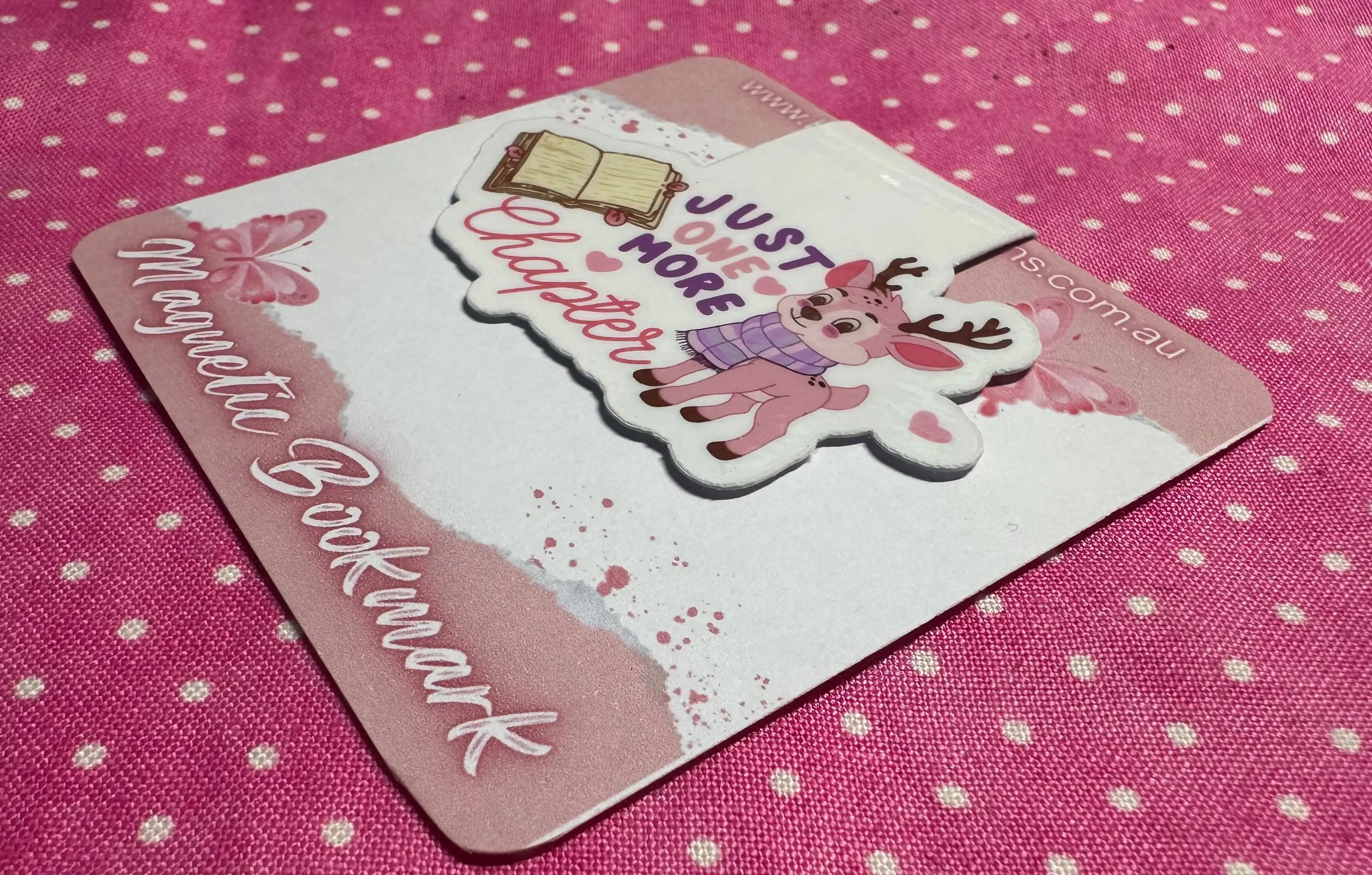 Magnetic bookmark with cartoon design on a pink polka dot background