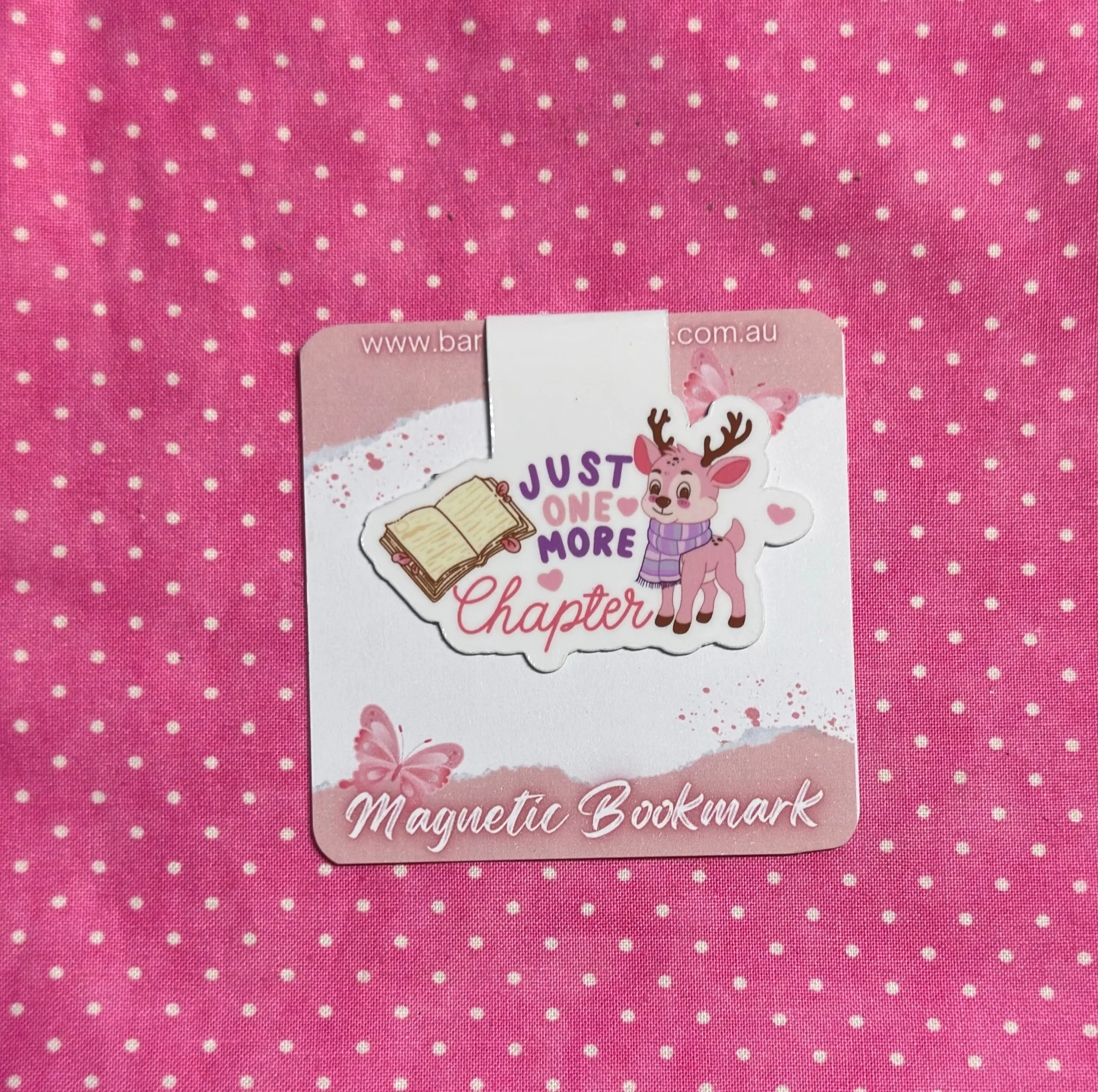 Magnetic bookmark with a cartoon deer and text on a pink polka dot background
