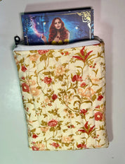 Floral-patterned pouch with a product inside on a light gray background